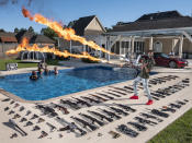 In this image released by World Press Photo, Thursday April 15, 2021, by Gabriele Galimberti for National Geographic, part of a series titled The 'Ameriguns' which won first prize in the Portraits Stories category, shows Torrell Jasper (35) poses with his firearms in the backyard of his house in Schriever, Louisiana, USA, on April 14, 2019. A former US Marine, he learned to shoot from his father as a child. (Gabriele Galimberti for National Geographic, World Press Photo via AP)