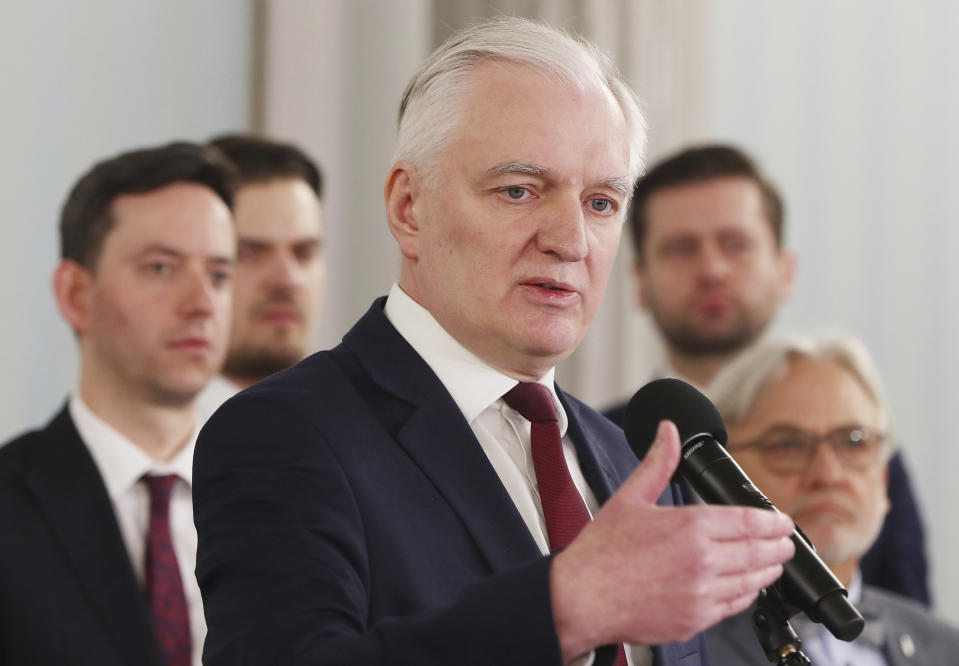 Deputy prime minister Jaroslaw Gowin,center, announces to reporters that he has resigned from his government position in Warsaw, Poland, on Monday April 6, 2020. Gowin, who also held the role of minister of science and higher education, resigned after he failed to persuade the government to postpone the presidential election by two years because of the coronavirus pandemic. Uncertainty over whether Poland will hold a postal presidential election during the pandemic deepened due to Gowin's resignation, which also left the ruling party without the votes it needed to change the law to hold a postal vote..(AP Photo/Czarek Sokolowski)