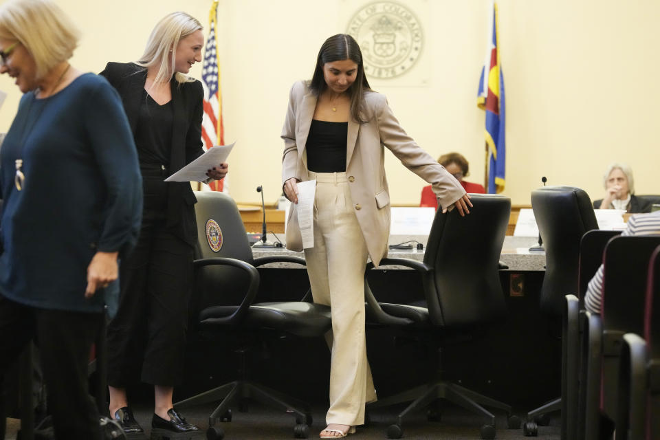 Emma Warford, center, a patient ambassador for pediatric mental health at Children's Hospital Colorado and a senior at Rock Canyon High School in Highlands Ranch, Colo., heads back to the gallery after delivering testimony during a Colorado Senate hearing on measures to address eating disorders Thursday, March 23, 2023, in the State Capitol in Denver. Lawmakers in states including Colorado, California, Texas and New York are taking big legislative swings at the eating disorder crisis that is bedeviling America's populous. (AP Photo/David Zalubowski)