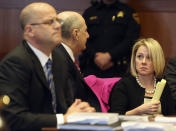 New Jersey Gov. Chris Christie's former Deputy Chief of Staff Bridget Anne Kelly, right, talks with her attorney Michael Critchley, center, as former Christie campaign director William Stepien's attorney Kevin Marino, left, looks on during a hearing Tuesday, March 11, 2014, in Trenton, N.J. Attorneys for Kelly and Stepien were in court to try to persuade a judge not to force them to turn over text messages and other private communications to New Jersey legislators investigating the political payback scandal ensnaring Christie's administration. (AP Photo/The Record of Bergen County, Chris Pedota, Pool)