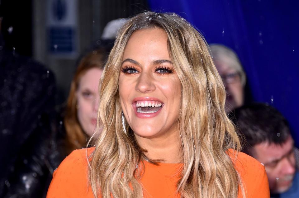 Caroline Flack laughing in snow. (PA Images)