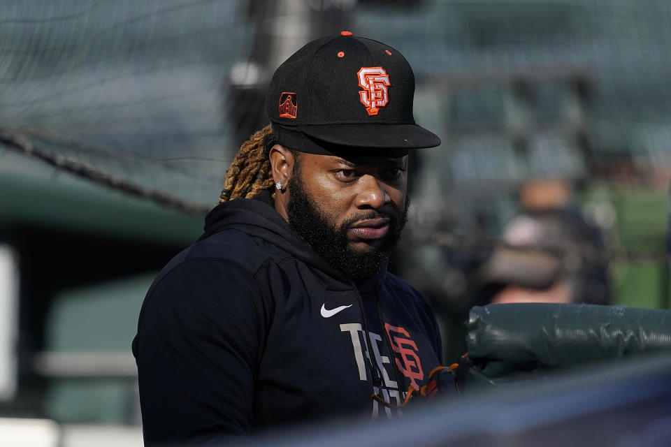 San Francisco Giants pitcher Johnny Cueto stands in the dugout during a baseball practice in San Francisco, Tuesday, Oct. 5, 2021. (AP Photo/Jeff Chiu)