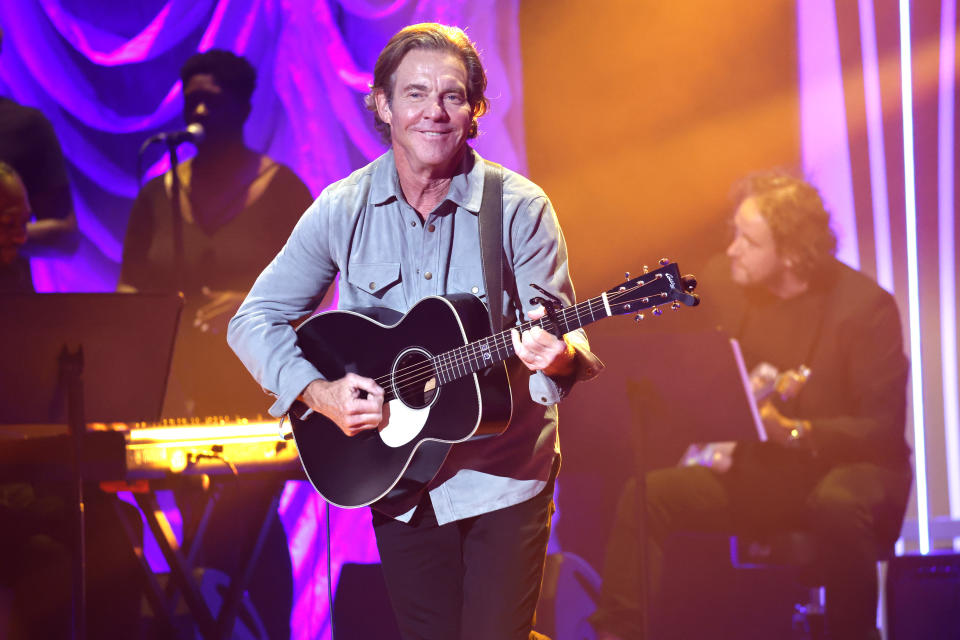 Dennis Quaid playing guitar