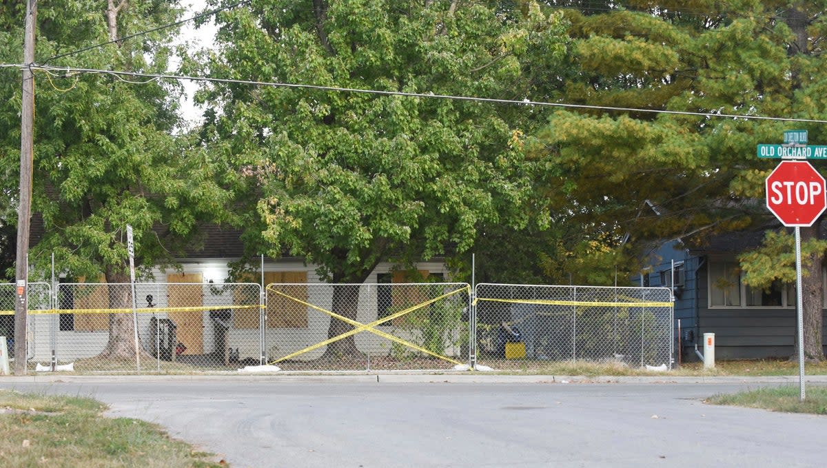 Police tape blocks off the residence of Timothy M Haslett Jr, after the home was boarded up and fenced off Monday, 10 October 2022, in Missouri’s Excelsior Springs city  (AP)