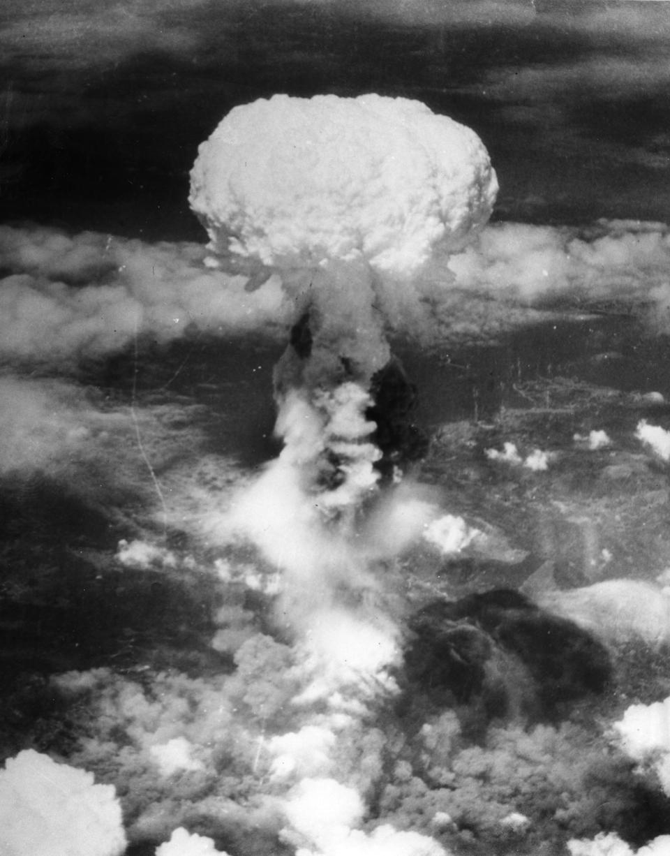 FILE - In this Aug. 9, 1945, file photo, a giant column of smoke rises more than 60,000 feet into the air, after the second atomic bomb ever used in warfare explodes over the Japanese port town of Nagasaki, dropped by the U.S. Army Air Forces B-29 plane "Bockscar." The city of Nagasaki in southern Japan marks the 75th anniversary of the U.S. atomic bombing of Aug. 9, 1945. Japan surrendered on Aug. 15, ending World War II and its nearly a half-century aggression toward Asian neighbors. Dwindling survivors, whose average age exceeds 83, increasingly worry about passing their lessons on to younger generations. (AP Photo, File)