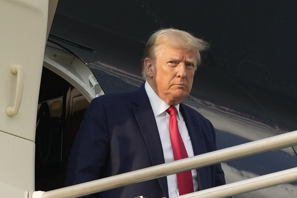 Former President Donald Trump steps off his plane as he arrives at Hartsfield-Jackson Atlanta International Airport, Thursday, Aug. 24, 2023, in Atlanta. (AP Photo/Alex Brandon)