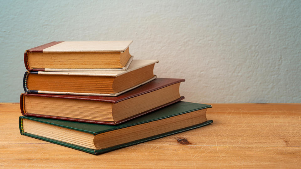 stack of old books: genius uses for dryer sheets