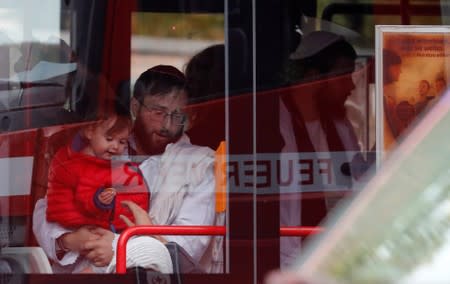 People are being escorted with a bus away from the site of a shooting in Halle