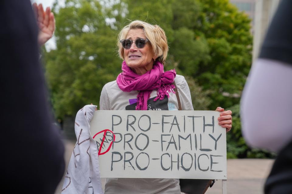 Susan Quinn holds her sign in support of Issue 1, the November ballot question that, if approved, would enshrine abortion rights in the Ohio constitution.