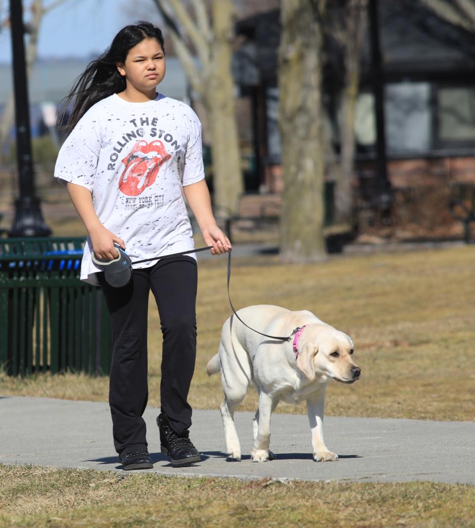 Layla Sunshine Foster Walks with her dog Callie at Waryas park on a 60 degree day in the City of Poughkeepsie on February 15, 2023.