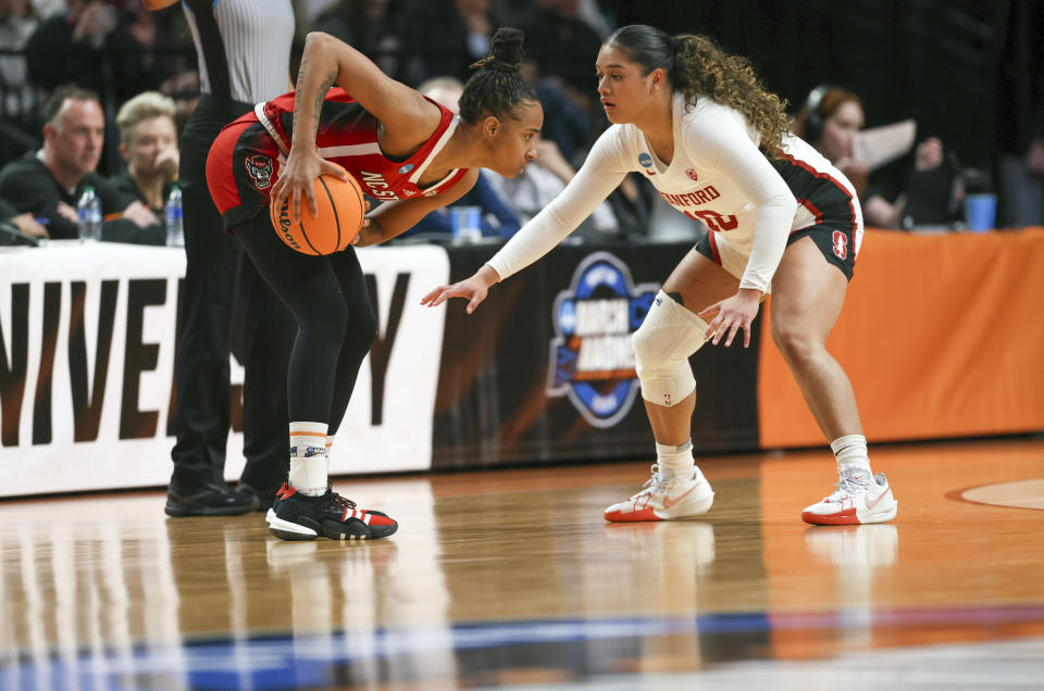 North Carolina State guard Aziaha James, left, looks to get around the defense of Stanford guard Talana Lepolo during the first half of a Sweet 16 college basketball game in the women's NCAA Tournament, Friday, March 29, 2024, in Portland, Ore. (AP Photo/Howard Lao)