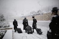 Ultra-Orthodox Jewish men walk on a snow-covered road in winter in Jerusalem December 12, 2013. Schools and offices in Jerusalem and parts of the occupied West Bank were closed and public transport briefly suspended after heavy snowfall on Thursday. REUTERS/Amir Cohen (JERUSALEM - Tags: ENVIRONMENT TPX IMAGES OF THE DAY)