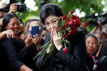 Ousted former Thai prime minister Yingluck Shinawatra greets supporters as she arrives at the Supreme Court in Bangkok, Thailand July 21, 2017. REUTERS/Chaiwat Subprasom