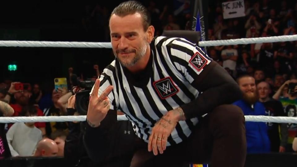  CM Punk holding up two fingers to Drew McIntyre with a smirk on his face. . 