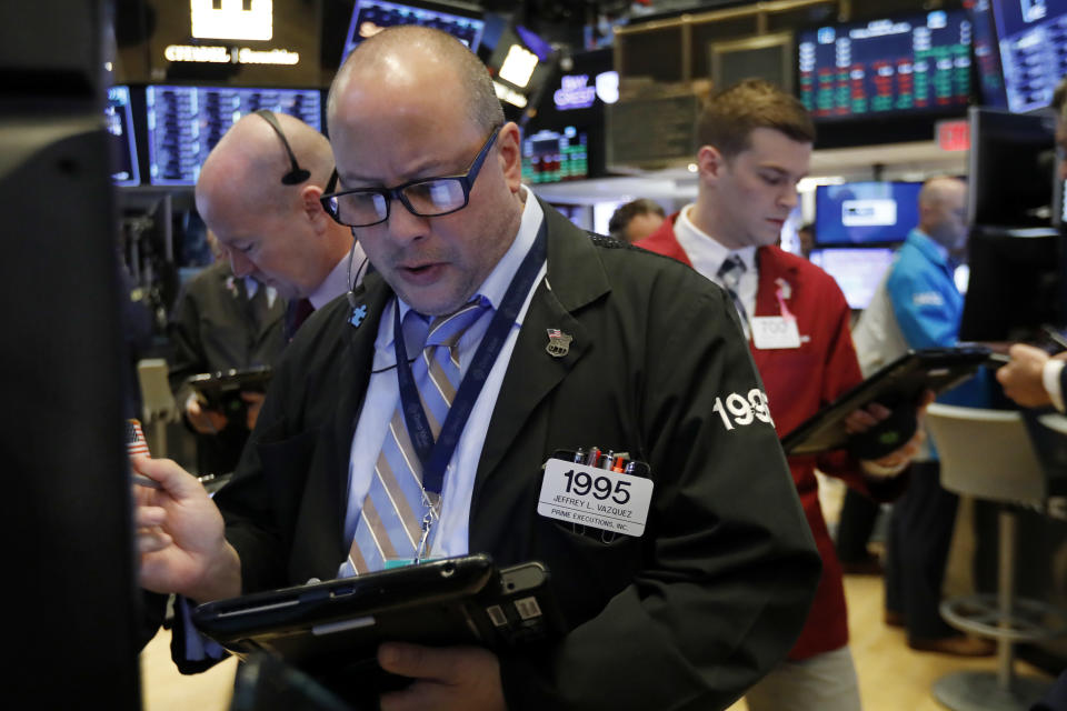 Trader Jeffrey Vazquez, center, works on the floor of the New York Stock Exchange, Friday, Oct. 26, 2018. Stocks are opening broadly lower on Wall Street, a day after a massive surge, as a number of big companies reported disappointing results. (AP Photo/Richard Drew)