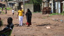 Guinean wrestler Fatoumata Yarie Camara walks with her mother near her house in Conakry, Guinea, Monday July 19, 2021. A West African wrestler's dream of competing in the Olympics has come down to a plane ticket. Fatoumata Yarie Camara is the only Guinean athlete to qualify for these Games. She was ready for Tokyo, but confusion over travel reigned for weeks. The 25-year-old and her family can't afford it. Guinean officials promised a ticket, but at the last minute announced a withdrawal from the Olympics over COVID-19 concerns. Under international pressure, Guinea reversed its decision. (AP Photo/Youssouf Bah)