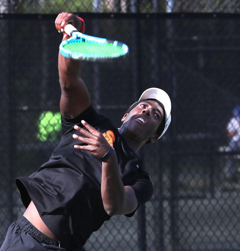 Spruce Creek's Demario Dawkins serves during a doubles match with teammate Zane Ensminger in the District 2-4A Tournament, Tuesday, April 16, 2024, at the Palm Coast Tennis Center.