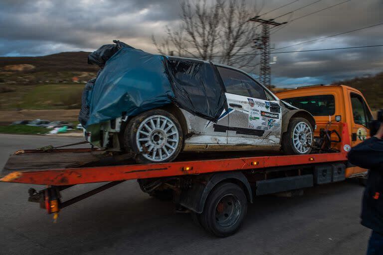 The accidented car is taken away from the road near the crash site where a vehicle taking part in the Esztergom Nyerges Rally veered off from the road on March 24, 2024, near Bajot, 55kms away from Budapest. Four people were killed and several others injured when a vehicle competing in a Hungarian rally on March 24 afternoon skidded off the road and crashed into spectators, authorities said. According to a police statement, a vehicle taking part in the Esztergom Nyerges Rally in northern Hungary, for reasons yet unclear, veered off the road and crashed into spectators. (Photo by FERENC ISZA / AFP)