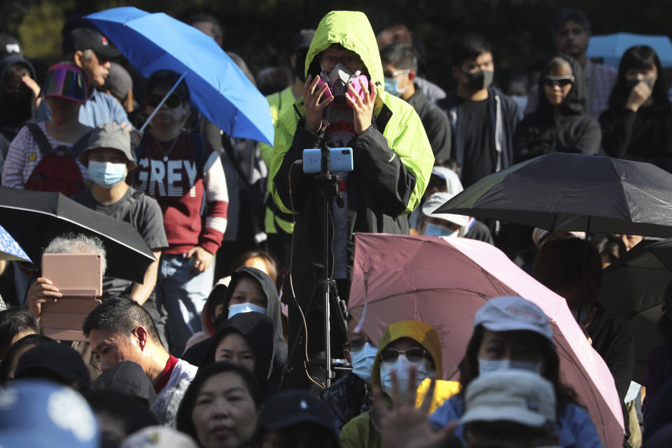 A protester wears a gas mask during a rally for students and elderly pro-democracy demonstrators in Hong Kong, Saturday, Nov. 30, 2019. Hundreds of Hong Kong pro-democracy activists rallied Friday outside the British Consulate, urging the city's former colonial ruler to emulate the U.S. and take concrete actions to support their cause, as police ended a blockade of a university campus after 12 days. (AP Photo/Ng Han Guan)
