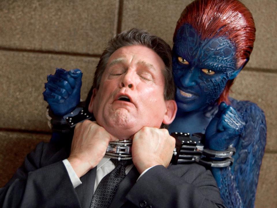 Blue lady: Romijn’s Mystique strangles actor Anthony Heald in ‘X-Men: The Last Stand’ (Shutterstock)