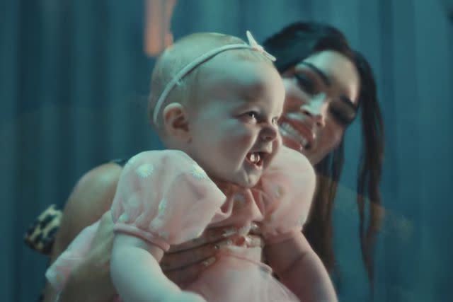 <p>MGK/Youtube</p> Baby Violet and Megan Fox in "Lonely Road"