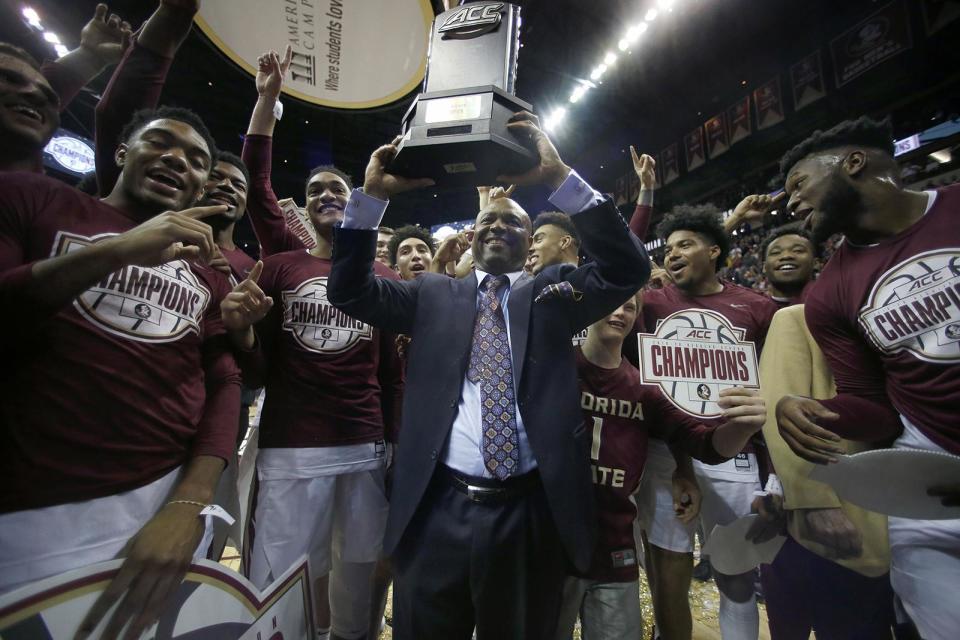 Florida State basketball coach Leonard Hamilton, seen here hoisting the ACC regular season championship trophy in 2021, could face an awkward career exit as he enters the final year of his contract at age 75 after three years of not going to the NCAA tournament.