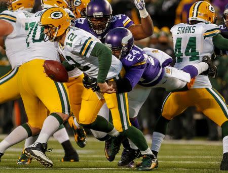 Minnesota Vikings cornerback Captain Munnerlyn (24) sacks Green Bay Packers quarterback Aaron Rodgers (12) in the second quarter at TCF Bank Stadium. The Packers win 30-13. Mandatory Credit: Bruce Kluckhohn-USA TODAY Sports