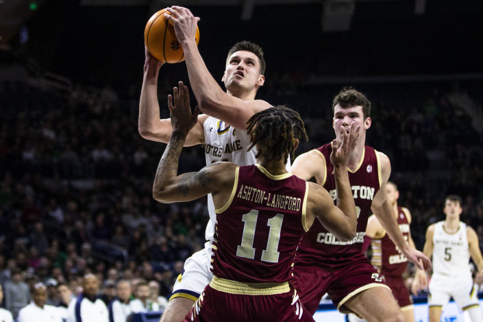 Notre Dame's Nate Laszewski (14) drives against Boston College's Makai Ashton-Langford (11) as Quinten Post (12) trails him during the second half of an NCAA college basketball game Saturday, Jan. 21, 2023 in South Bend, Ind. (AP Photo/Michael Caterina)