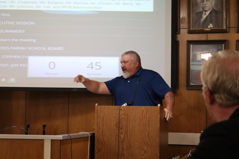 James Lucas, parent of a Bolton High School student, points to Rapides Parish School Board members during a meeting Tuesday. Lucas accused board members of already making up their minds to close four Alexandria schools before the meeting.