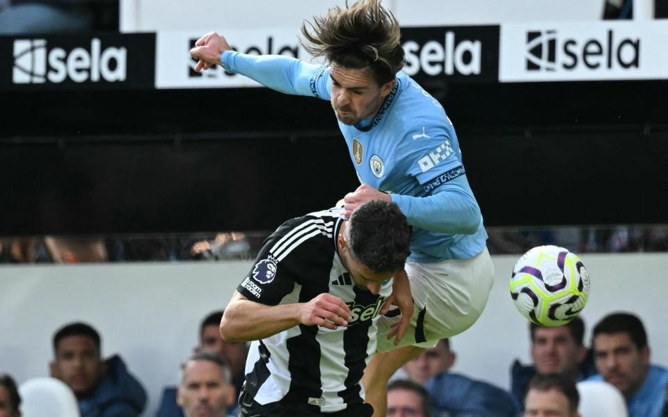 Newcastle United's Swiss defender #05 Fabian Schar (L) and Manchester City's English midfielder #10 Jack Grealish (R) fight for the ball during the English Premier League football match between Newcastle United and Manchester City at St James' Park