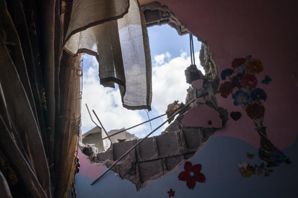 A hole in the wall of a children's room remains after the neighboring home of Ramez al-Masri was destroyed in an air-strike prior to a cease-fire reached after an 11-day war between Gaza's Hamas rulers and Israel, Sunday, May 23, 2021, in Beit Hanoun, the northern Gaza Strip. (AP Photo/John Minchillo)