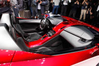 Starting with the everyday 700-hp Aventador, Lamborghini taunted the bull even further by removing the roof, adding several aerodynamic panels and generally shucking weight from a car that only had 3,472 lbs. to begin with. Even the seat fabrics have been swapped for something Lamborghini calls "Carbonskin," a fabric made from carbon fibers that's at least a decade away from being used on a teenager's hat. With no windshield, the interior has to get some form of waterproofing; the rear mirror pops up like Wall-E's head from the center of the dash. It and the roll bars behind the driver are the highest points in the car.