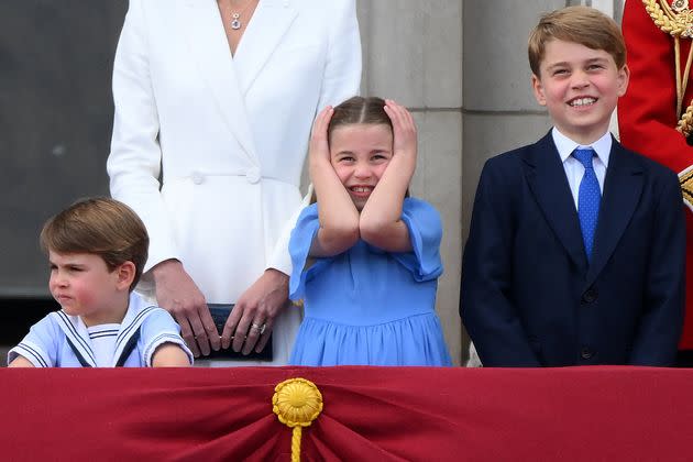 Charlotte's turn to cover her ears, while a very grown-up George grins! (Photo: DANIEL LEAL via Getty Images)