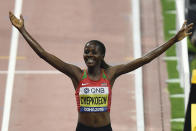 Beatrice Chepkoech, of Kenya,celebrates after crossing the finish line to win the women's 3000 meter steeplechase final during the World Athletics Championships in Doha, Qatar, Monday, Sept. 30, 2019. (AP Photo/Martin Meissner)