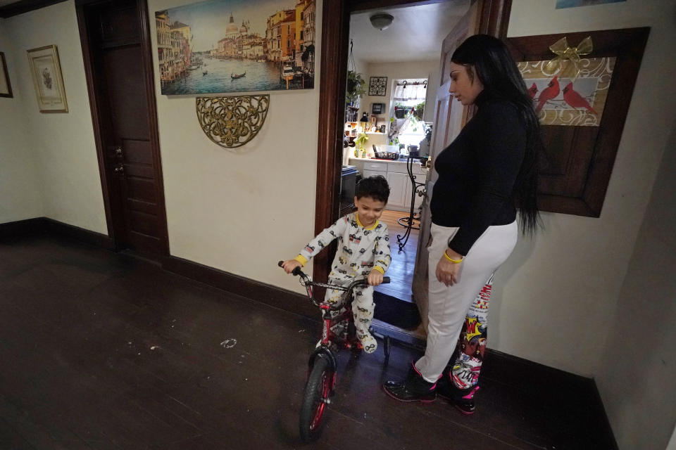 Isabel Miranda's 4-year-old son, Julian, rides his bike into the hallway, Wednesday, March 10, 2021, of their rental apartment in Haverhill, Mass. The Biden administration is extending a federal moratorium on evictions of tenants who've fallen behind on rent during the coronavirus pandemic. Miranda, who has an eviction hearing next month from the apartment, said she had mixed feelings about the extension. She worries that the courts and the landlord will not recognize the federal moratorium but also recognizes it gives her time to come up with the nearly $10,000 in back rent. (AP Photo/Elise Amendola)