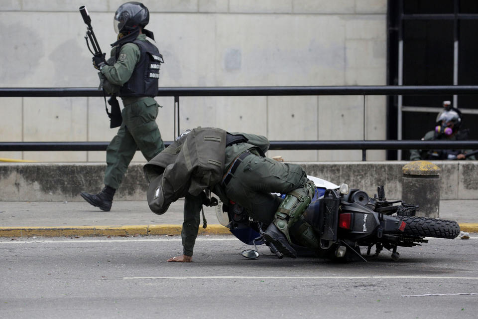 <p>Riot police officer falls of his motorcycle as demonstrators rally against Venezuela’s President Nicolas Maduro’s government in Caracas, Venezuela May 3, 2017. (Carlos Garcia Rawlins/Reuters) </p>