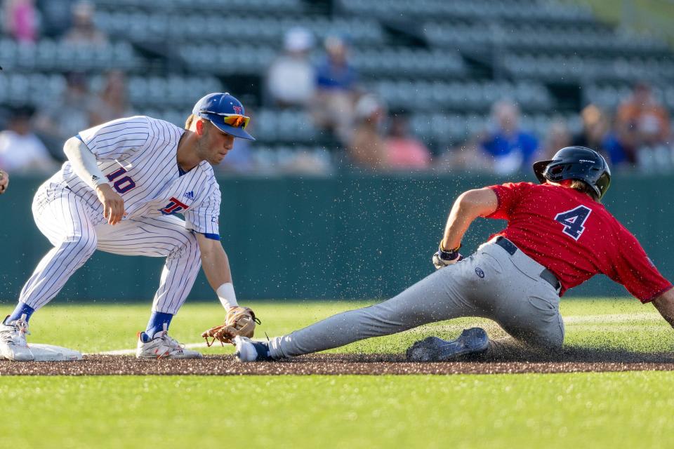 Louisiana Tech third baseman Logan McLeod (10) makes the tag for the out on DBU infielder George Specht (4) during an NCAA baseball game on Friday, June 3, 2022, in Austin, Texas. (AP Photo/Stephen Spillman)