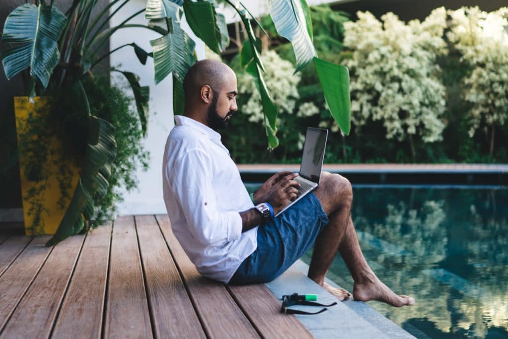 A man does work poolside in Indonesia.