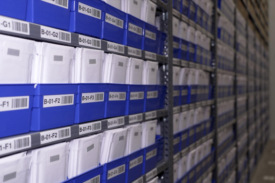 Stacks of collectibles fill shelves housed in a safe at Collectors Vault on Oct. 21, 2022, in Delaware. Inside the boxes are sports cards, baseball bats, Pokemon cards and other pricey memorabilia. (AP Photo/Davidde Corran)