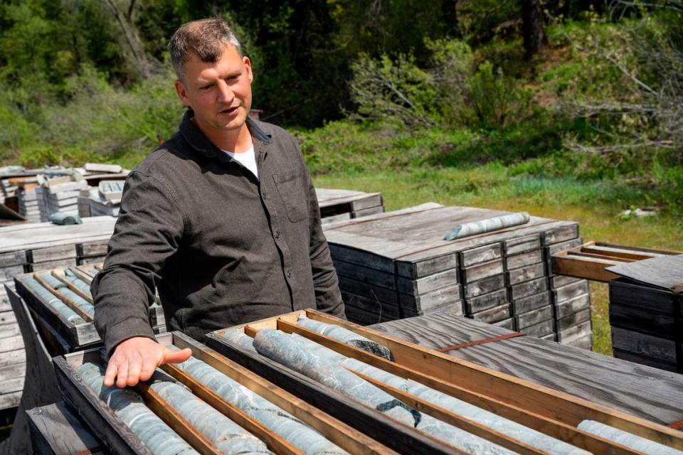 Rise Gold Corporation CEO Ben Mossman gestures in May towards some of the exploratory drilling samples – ones without gold – his company has taken in recent years at the historic Idaho-Maryland Mine near Grass Valley. The company says it has found gold near the mine’s existing tunnels.