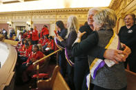 Equal Rights Amendment supporter Donna Granski, right, and Candy Graham, second from right from Midlothian Va., hug after the passage of the House ERA Resolution in the Senate chambers at the Capitol in Richmond, Va. Monday, Jan. 27, 2020. The resolution passed 27-12. (AP Photo/Steve Helber)