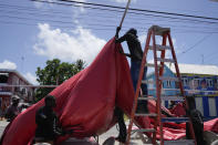 People disassemble a beach bar's awning in preparation for Hurricane Beryl, in Bridgetown, Barbados, Sunday, June 30, 2024. (AP Photo/Ramon Espinosa)