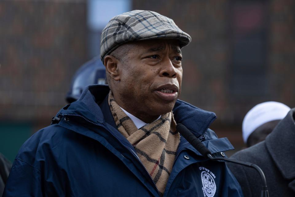 New York City Mayor Eric Adams speaks to the media Monday, Jan. 10, 2022, outside the apartment building where a deadly fire broke out on Sunday in the Bronx borough of New York.