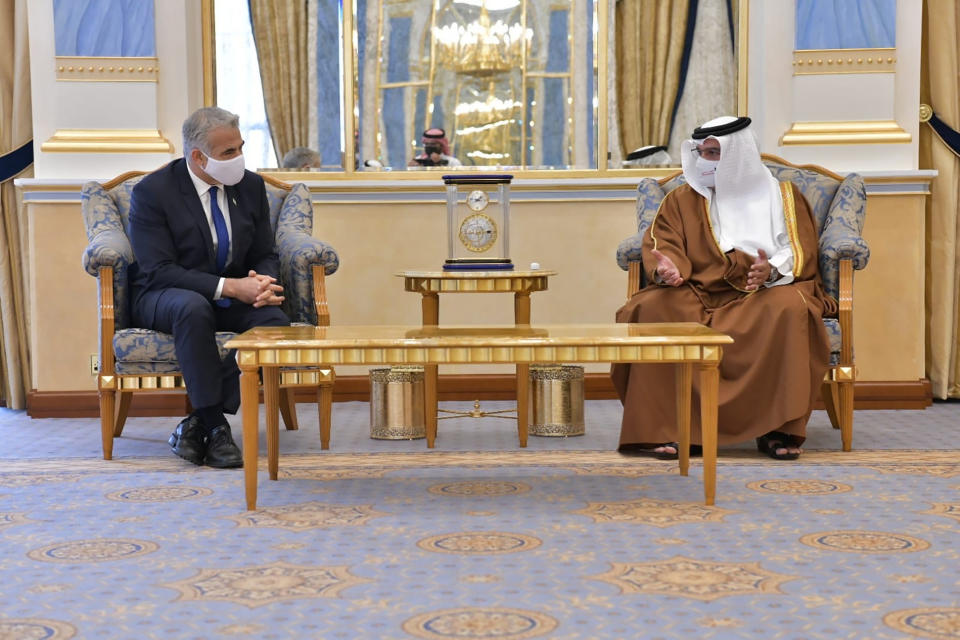 In this photo provided by the Israeli Government Press Office, Israel's Foreign Minister Yair Lapid, left, meet with Bahrain's Crown Prince Salman bin Hamad Al Khalifa, during the first high-level visit to the small Gulf state by a senior Israeli official since the signing of a landmark agreement to establish diplomatic ties between the two countries last year, in Manama, Bahrain, Thursday, Sept. 30, 2021. Lapid will inaugurate Israel’s embassy. (Shlomi Amshalem/GPO via AP)