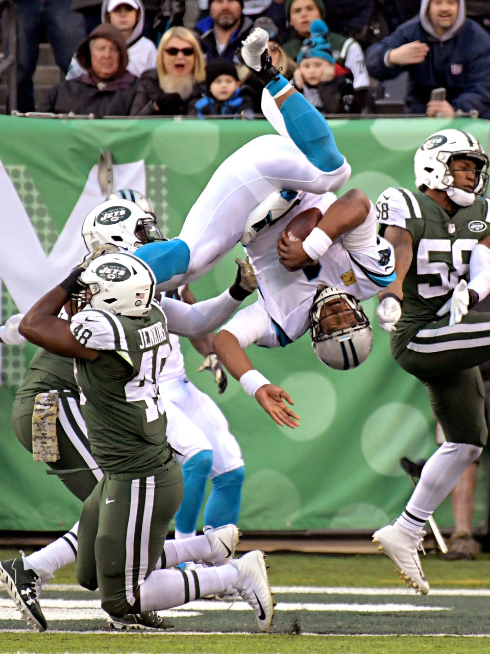 <p>Carolina Panthers quarterback Cam Newton (1) dives over a tackle-attempt by New York Jets outside linebacker Jordan Jenkins (48) on a two-point conversion during the second half of an NFL football game, Sunday, Nov. 26, 2017, in East Rutherford, N.J. (AP Photo/Bill Kostroun) </p>