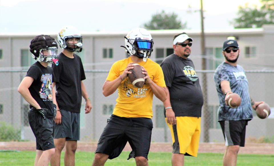 Pueblo East quarterbacks work on drills during practice at Heaton Middle school as they prepare for the upcoming season.