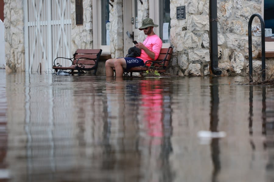 Eliah Corcoran sits on a bench in flood waters after Hurricane Idalia passed offshore on August 30, 2023 in Crystal River, Florida. Hurricane Idalia hit the Big Bend area on the Gulf Coast of Florida as a Category 3 storm. (Photo by Joe Raedle/Getty Images)