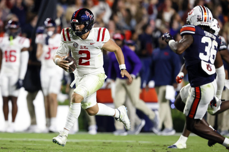 Mississippi quarterback Jaxson Dart (2) caries for a first down against Auburn during the second half of an NCAA college football game, Saturday, Oct. 21, 2023, in Auburn, Ala. (AP Photo/Butch Dill )