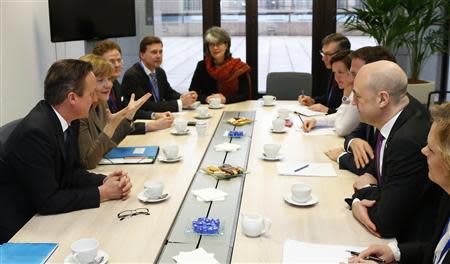 Britain's Prime Minister David Cameron, Germany's Chancellor Angela Merkel, Sweden's Prime Minister Fredrik Reinfeldt and Netherlands' Prime Minister Mark Rutte meet at the start of the second day of a European leaders summit in Brussels March 21, 2104. REUTERS/Yves Herman