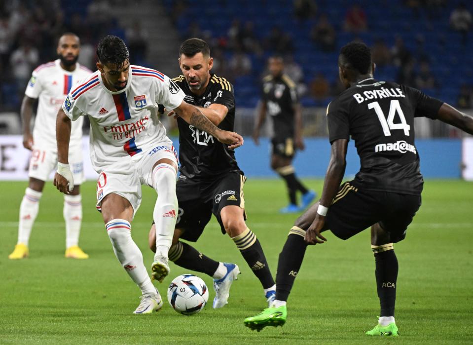 Lyon's Brazilian midfielder Lucas Paqueta (L) fights for the ball with Ajaccio's French midfielder Thomas Mangani (AFP via Getty Images)